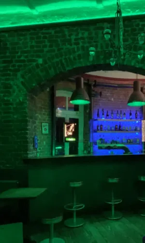 IMG 5449 Gemütliche Bar mit rustikalen Backsteinwänden, grüner LED-Beleuchtung und moderner Lounge-Atmosphäre, ideal für entspannte Abende und Treffen in entspannter Umgebung.